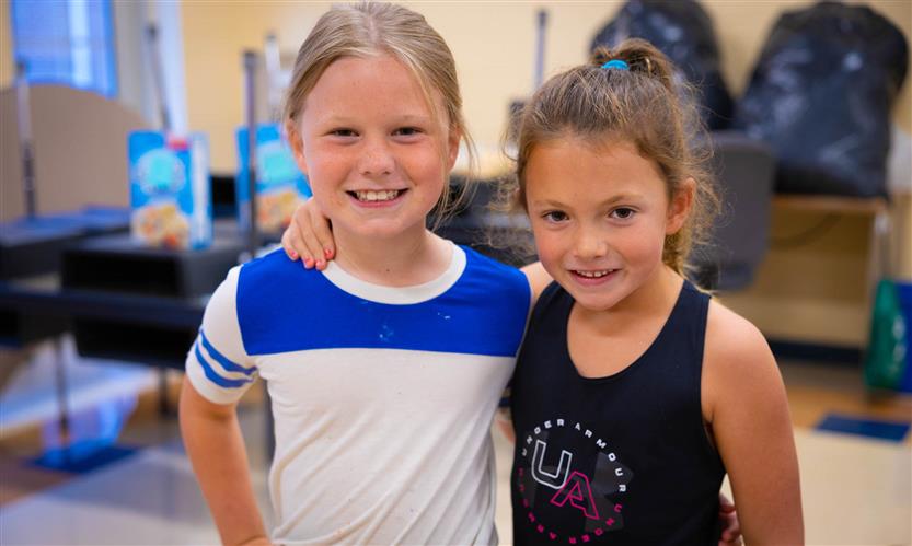 Two girls smile